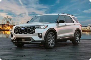 White Ford Explorer parked near a waterfront boardwalk
