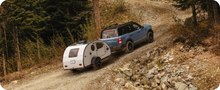 Family loading gear into the back of a Ford SUV