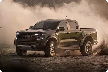 Ford Ranger pickup driving through dust on rough terrain