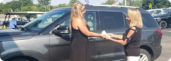 A customer and Dorian Ford team member complete a vehicle sale