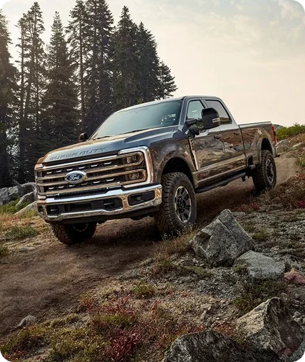 Ford Super Duty Crew Cab on a rocky forest trail