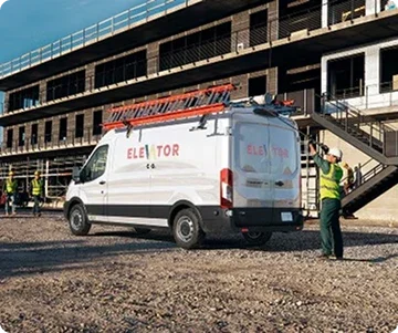 Ford Transit Cargo Van with a ladder rack parked at a construction site