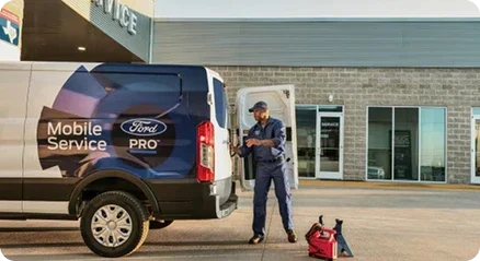 Ford Pro Mobile Service Transit van with a technician unloading tools