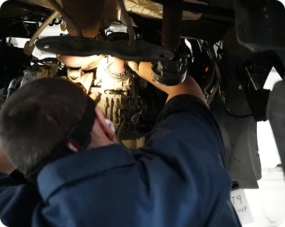 Dorian Ford technician working beneath a vehicle in the on-site, Ford-approved collision center