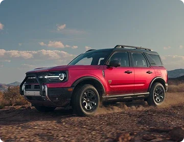 Red Ford Bronco Sport driving on a dirt trail